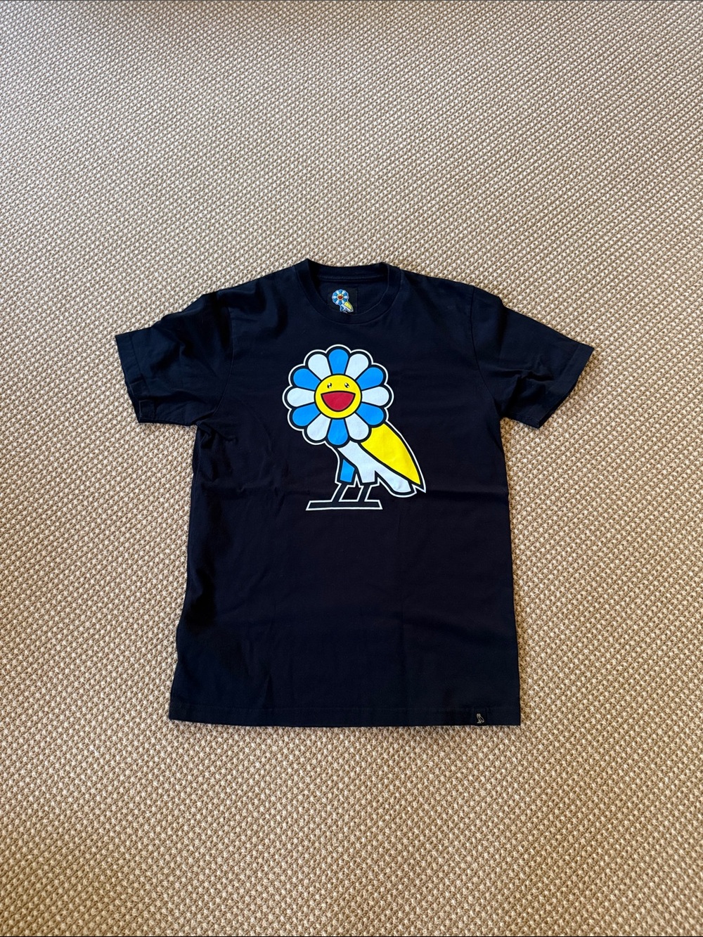 Black Graphic Tee with Smiling Flower Character